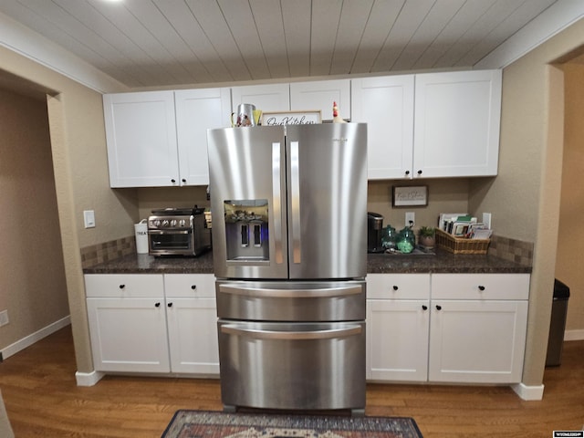 kitchen featuring light hardwood / wood-style flooring, wooden ceiling, white cabinets, and stainless steel refrigerator with ice dispenser