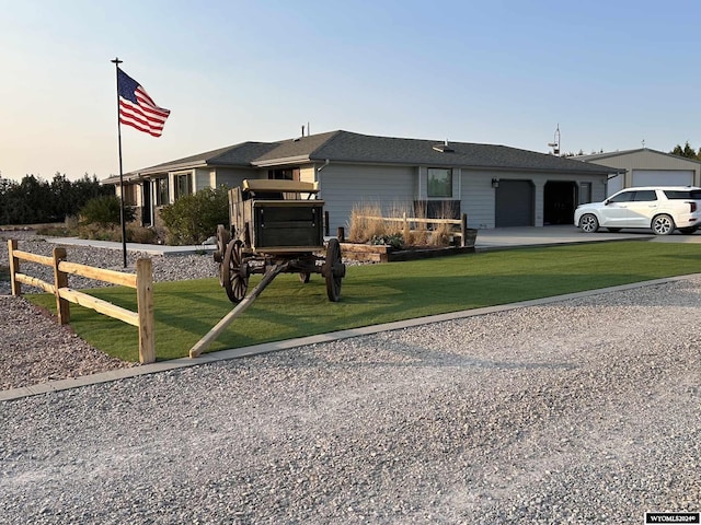 view of front of property featuring a garage and a lawn