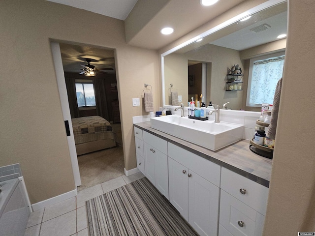 bathroom with tile patterned flooring, vanity, and ceiling fan