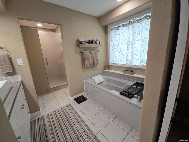 bathroom featuring vanity, tile patterned floors, and a tub