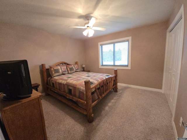 carpeted bedroom featuring a closet and ceiling fan