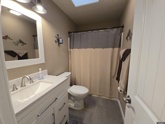 bathroom featuring vanity, hardwood / wood-style floors, a shower with curtain, and toilet