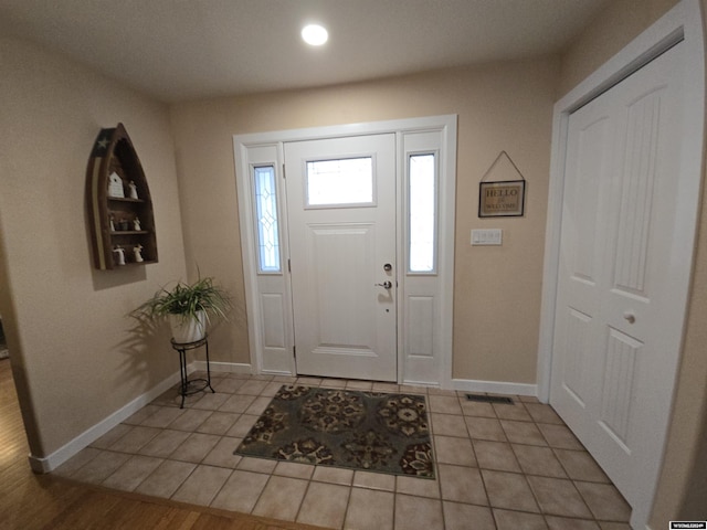 entryway with light tile patterned floors