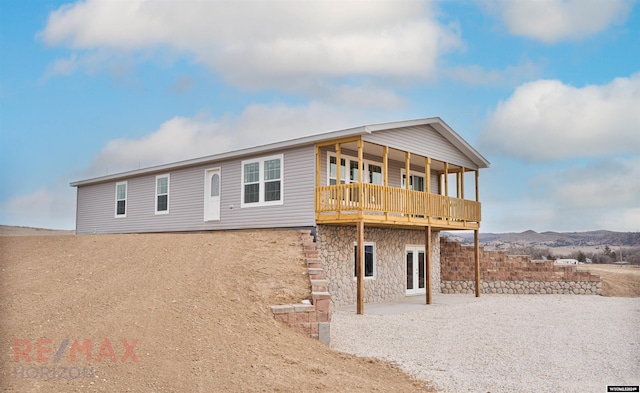 back of house featuring a mountain view and french doors