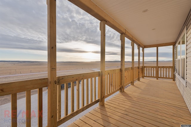 wooden deck with a rural view