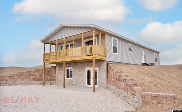 rear view of property featuring a wooden deck and cooling unit