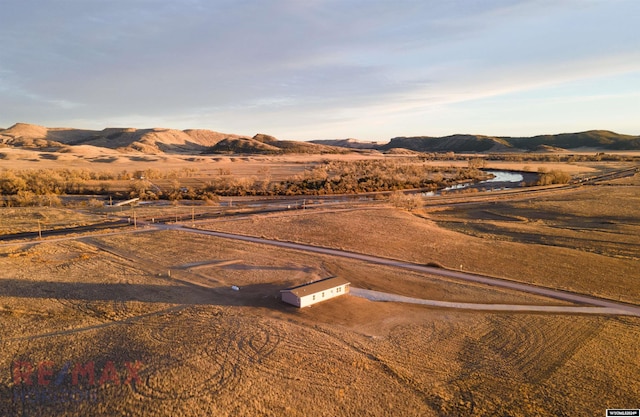 property view of mountains featuring a rural view and a water view