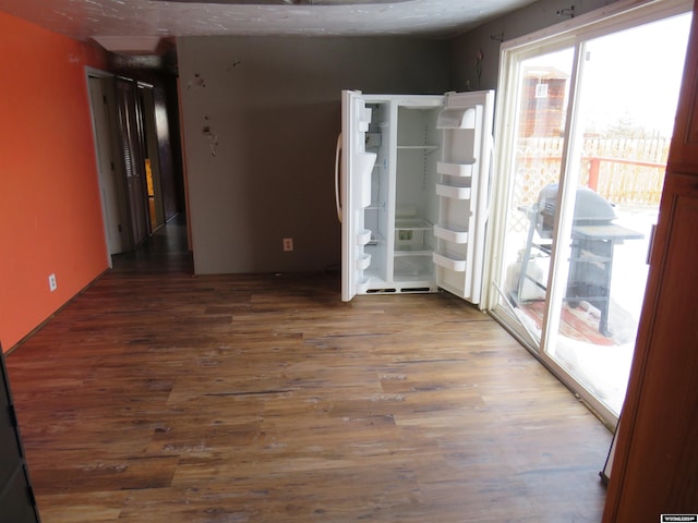 empty room featuring dark wood-type flooring