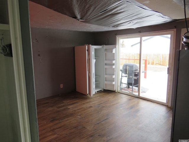 spare room with dark wood-type flooring