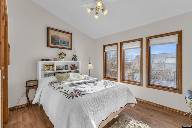 9 Spotted Tail Cir, Rock Springs, WY 82901 - bedroom with lofted ceiling, wood finished floors, and multiple windows
