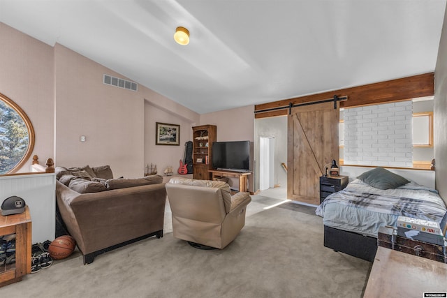 9 Spotted Tail Cir, Rock Springs, WY 82901 - bedroom with a barn door, vaulted ceiling, and light carpet