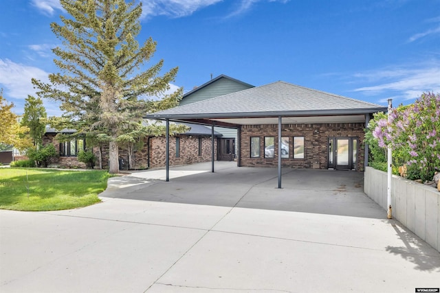 9 Spotted Tail Cir, Rock Springs, WY 82901 - back of house with concrete driveway, a shingled roof, and brick siding