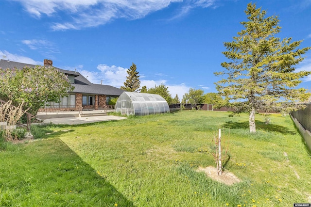 9 Spotted Tail Cir, Rock Springs, WY 82901 - fenced backyard featuring an exterior structure, an outdoor structure, and a patio