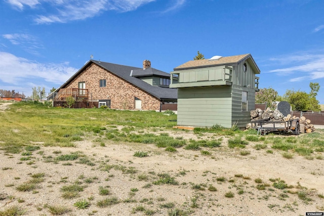 9 Spotted Tail Cir, Rock Springs, WY 82901 - rear view of property featuring board and batten siding and a chimney