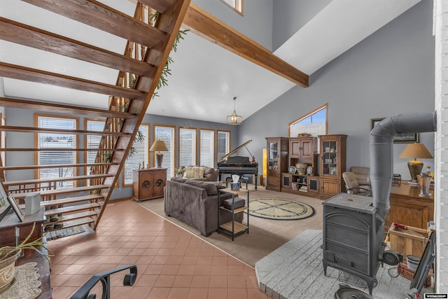 9 Spotted Tail Cir, Rock Springs, WY 82901 - living room with a wood stove, light tile patterned flooring, beam ceiling, and high vaulted ceiling