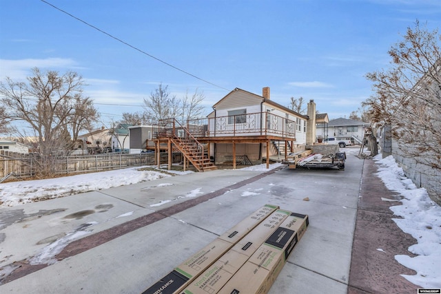 snow covered property featuring a deck