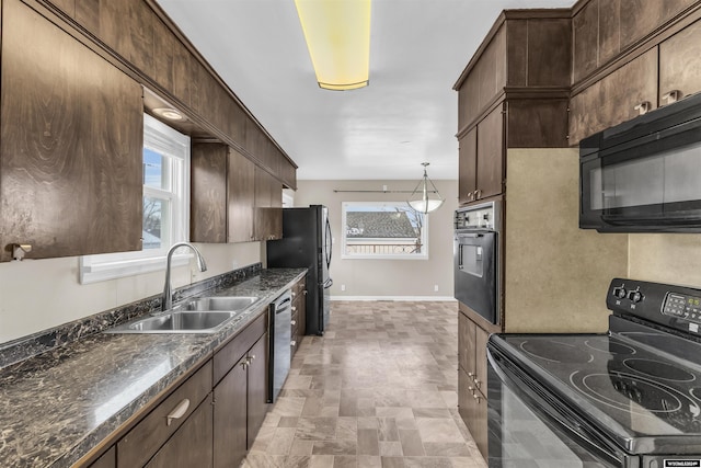 kitchen featuring a wealth of natural light, sink, black appliances, and dark brown cabinets