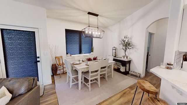 dining area with a chandelier and light hardwood / wood-style floors