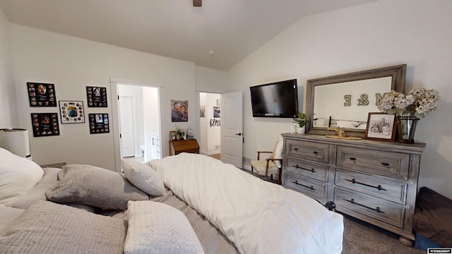 bedroom featuring vaulted ceiling and dark colored carpet