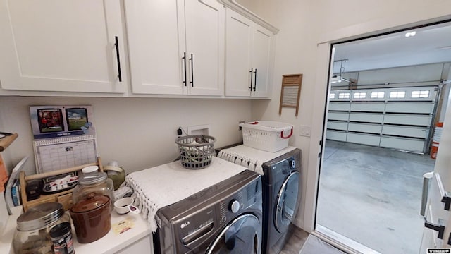 washroom featuring cabinets and washing machine and dryer