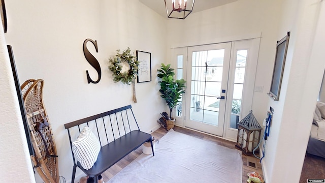 foyer entrance with hardwood / wood-style floors and an inviting chandelier