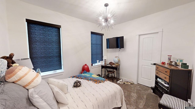 bedroom featuring carpet and a chandelier