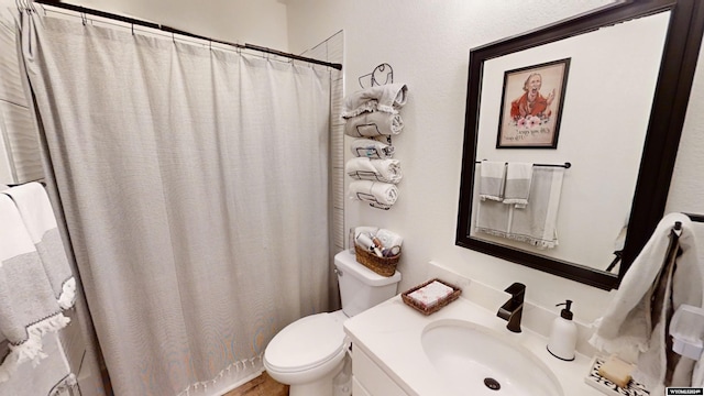 bathroom featuring vanity and toilet