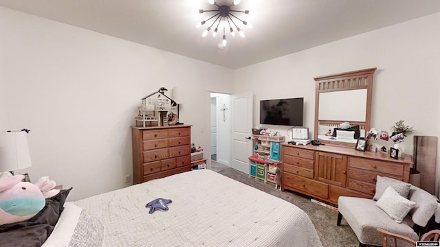 carpeted bedroom with a chandelier