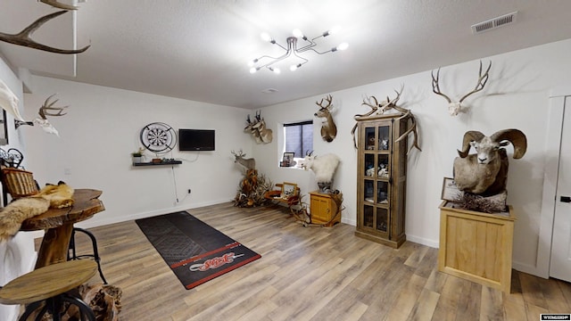 living area featuring a chandelier and wood-type flooring