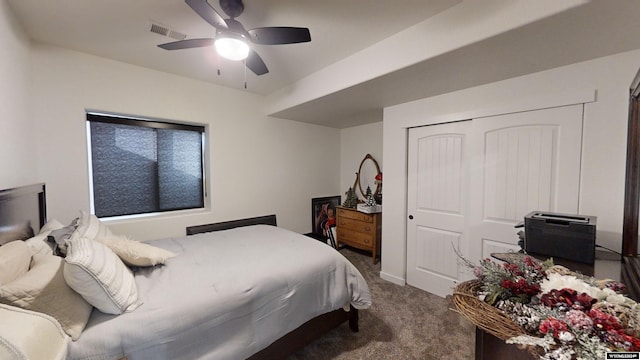 carpeted bedroom featuring ceiling fan and a closet