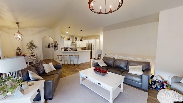 living room with a notable chandelier and hardwood / wood-style flooring