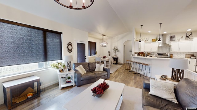 living room featuring an inviting chandelier and light wood-type flooring