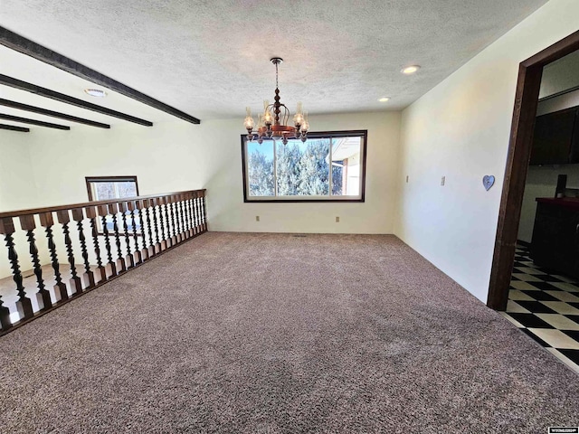 empty room featuring carpet, beam ceiling, a textured ceiling, and an inviting chandelier