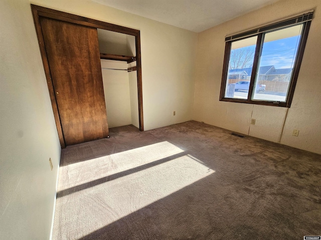 unfurnished bedroom with carpet and a closet