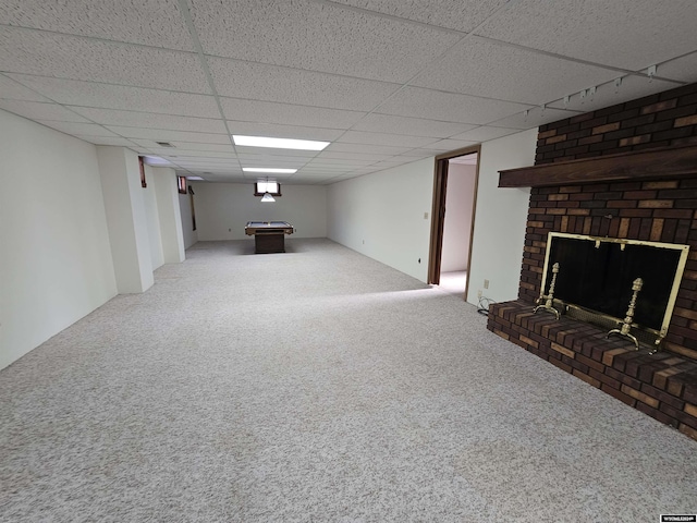 basement featuring a paneled ceiling, carpet floors, a fireplace, and billiards