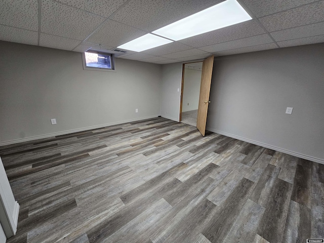 basement with wood-type flooring and a drop ceiling