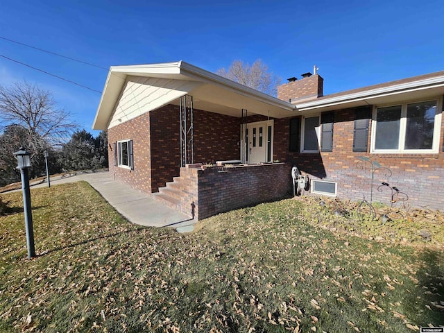 view of side of property with a lawn