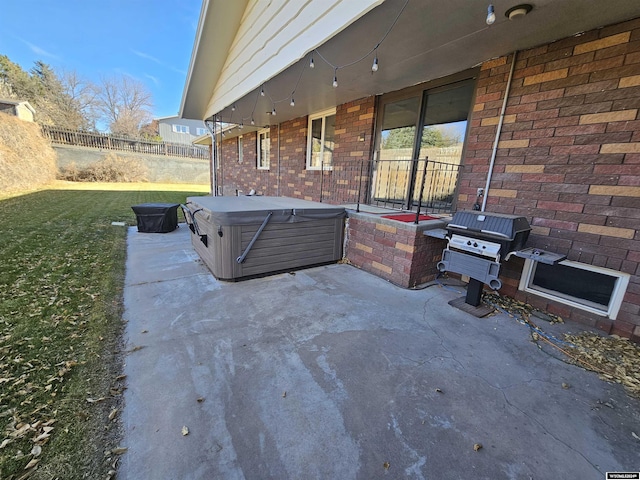 view of patio featuring a hot tub and a grill