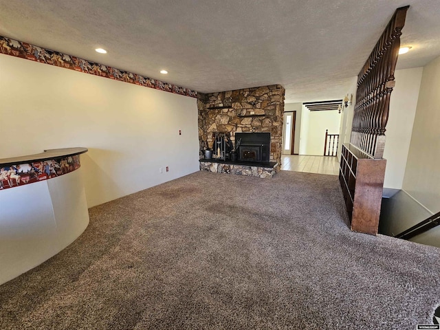 unfurnished living room with carpet and a textured ceiling