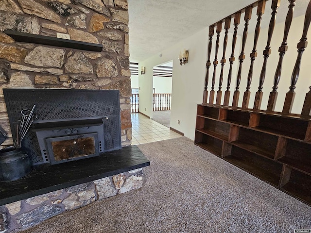 room details with a fireplace, a textured ceiling, and carpet floors