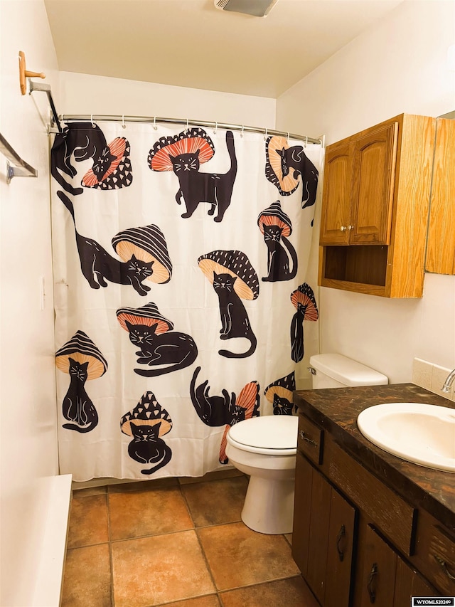 bathroom featuring vanity, toilet, and walk in shower