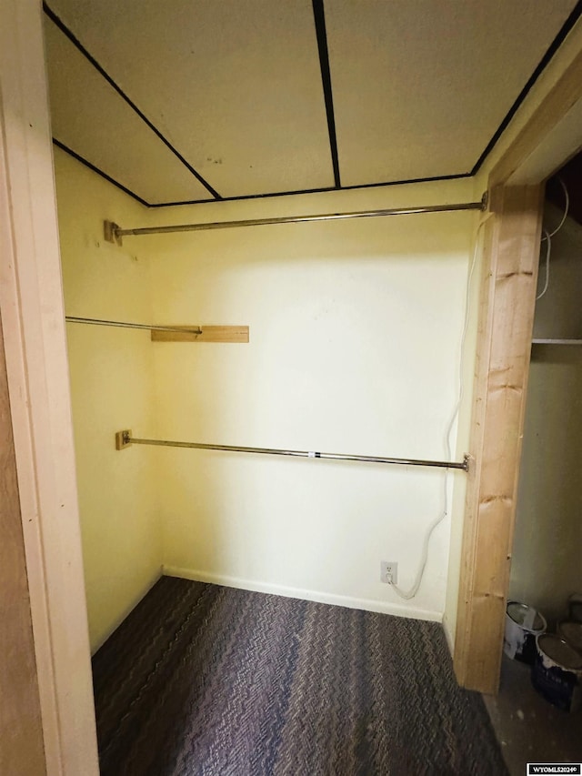 spacious closet featuring dark carpet