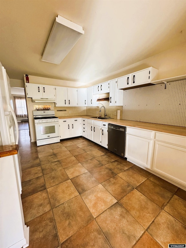 kitchen featuring stainless steel dishwasher, sink, dark tile patterned flooring, white cabinets, and white stove