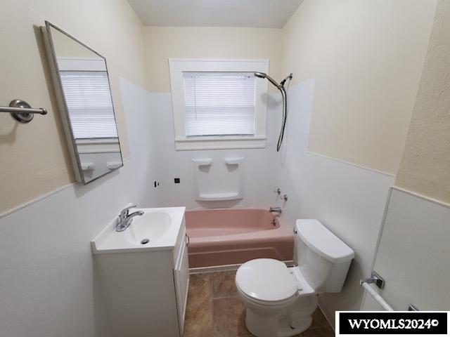 full bathroom with shower / tub combination, tile patterned flooring, vanity, and toilet