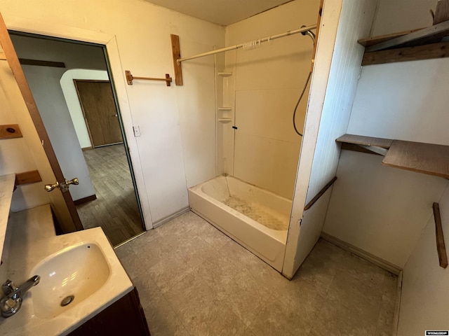 bathroom with a shower, hardwood / wood-style floors, and vanity