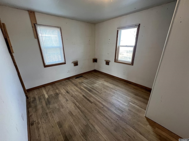 unfurnished room with hardwood / wood-style floors