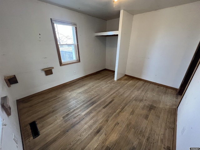 unfurnished bedroom with hardwood / wood-style floors