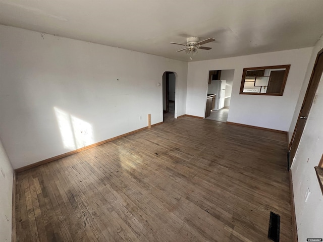 spare room featuring dark hardwood / wood-style floors and ceiling fan