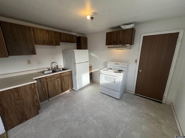 kitchen featuring white appliances, dark brown cabinetry, and sink