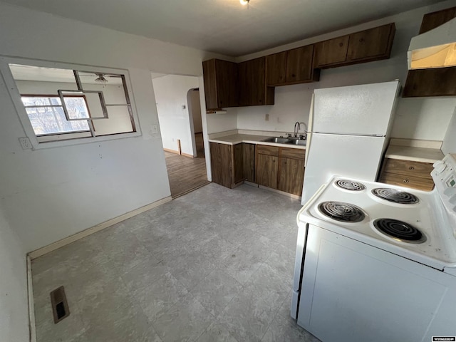 kitchen featuring white appliances, ventilation hood, sink, light hardwood / wood-style floors, and dark brown cabinetry